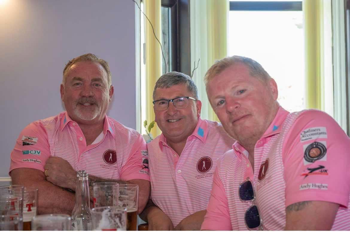 Three friends in pink golf shirts