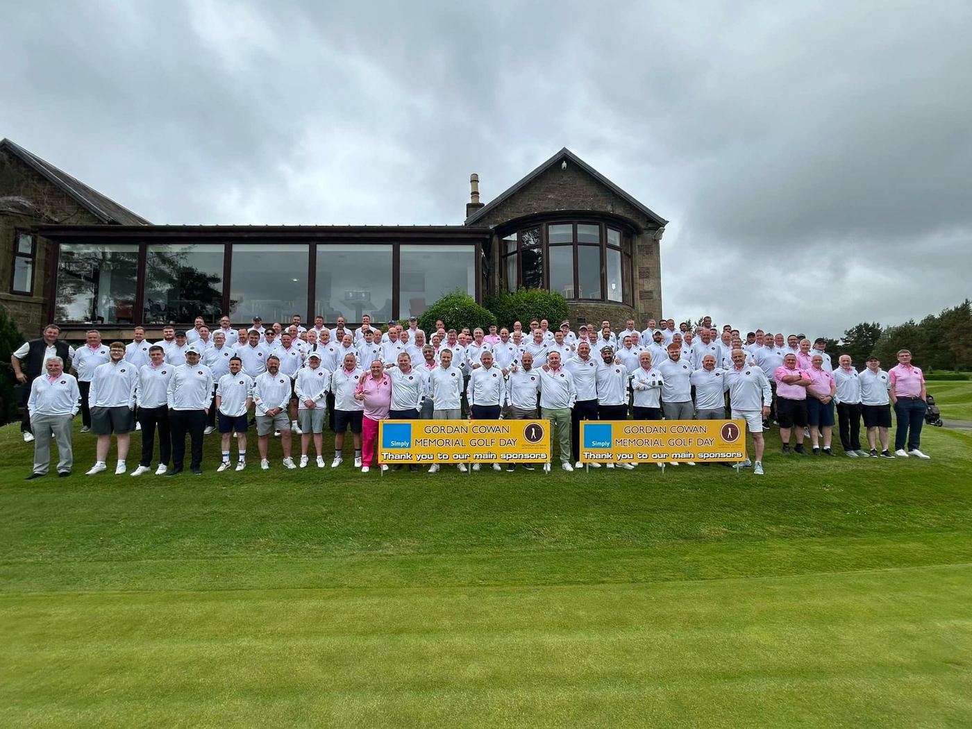 A large group of golfers outside the clubhouse