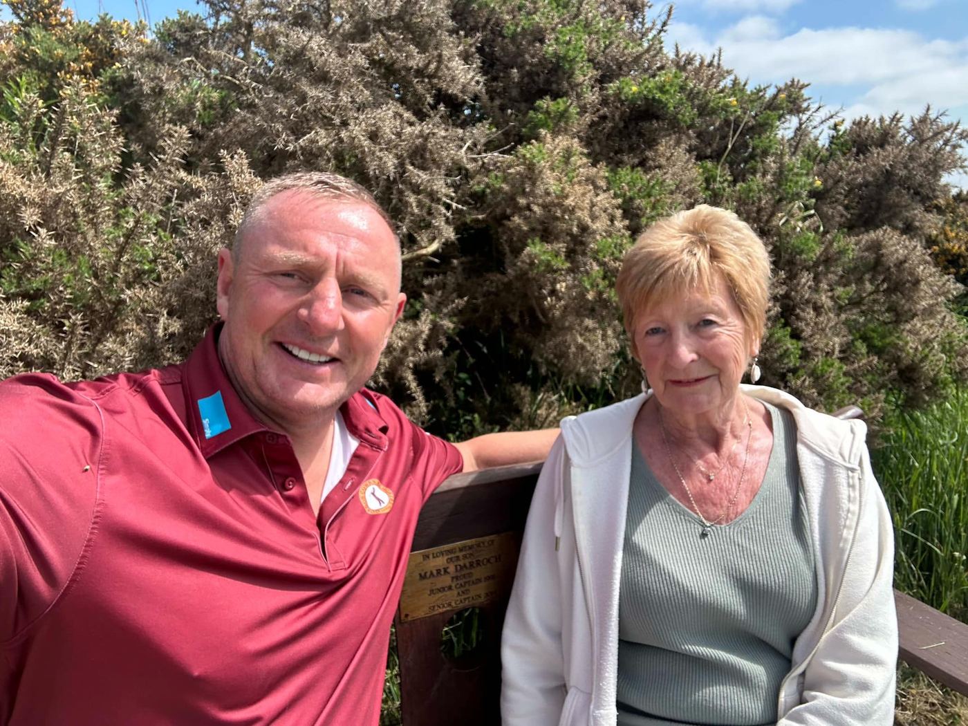 Two supporters smiling on the course