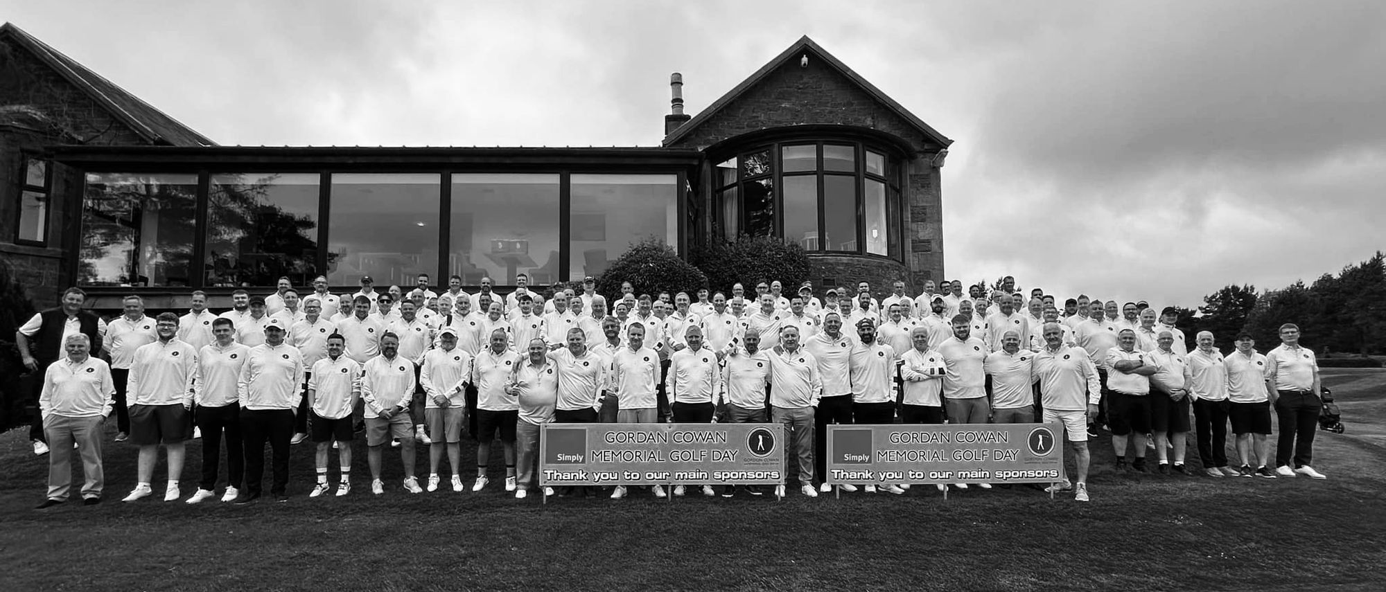 A large group of golfers in white shirts at the Gordon Cowan Memorial Golf Day