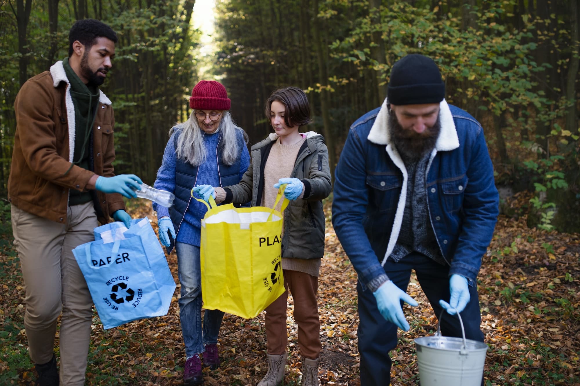 diverse-group-of-volunteers-cleaning-up-forest-from-waste-community-service-concept.jpg